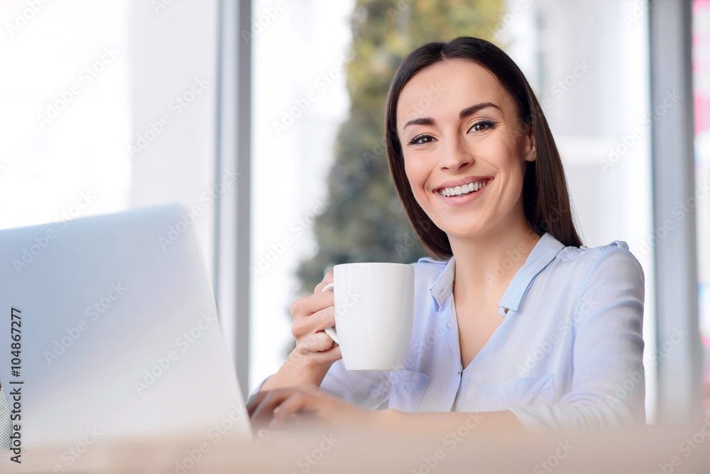 Pleasant business woman sitting at the table Pleasant business woman sitting at the table