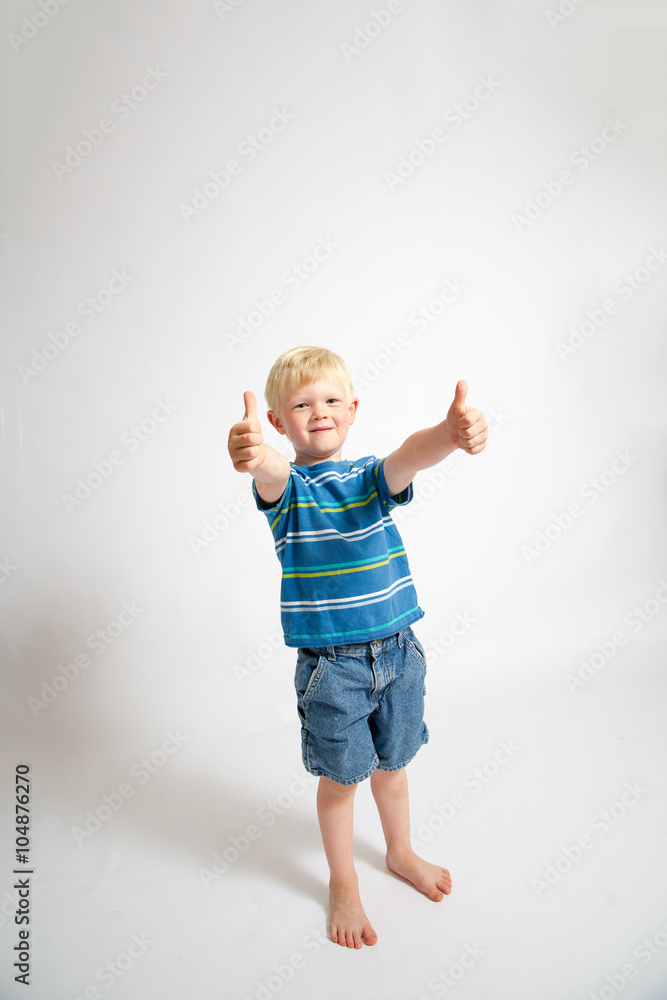 Young blonde boy giving the thumbs up sign. Young blonde boy giving the thumbs up sign.