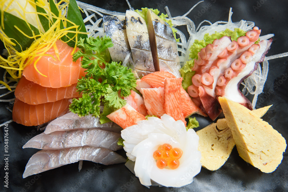 A colorful platter of sashimi sushi with tuna and crab sticks in A colorful platter of sashimi sushi with tuna and crab sticks in