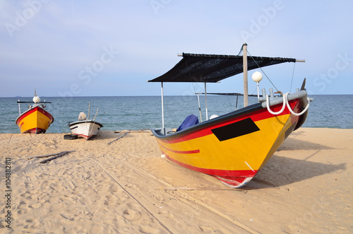 fisherman boat on the beach with one of it placed infront