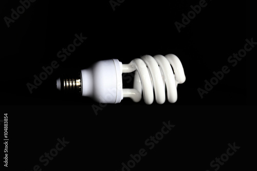 Energy saving fluorescent light bulb on Black background