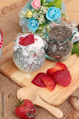 Chia seeds with milk and fresh strawberries.