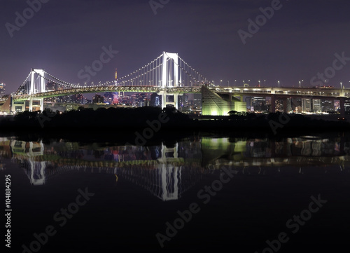Tokyo Rainbow Bridge with water reflection at Night