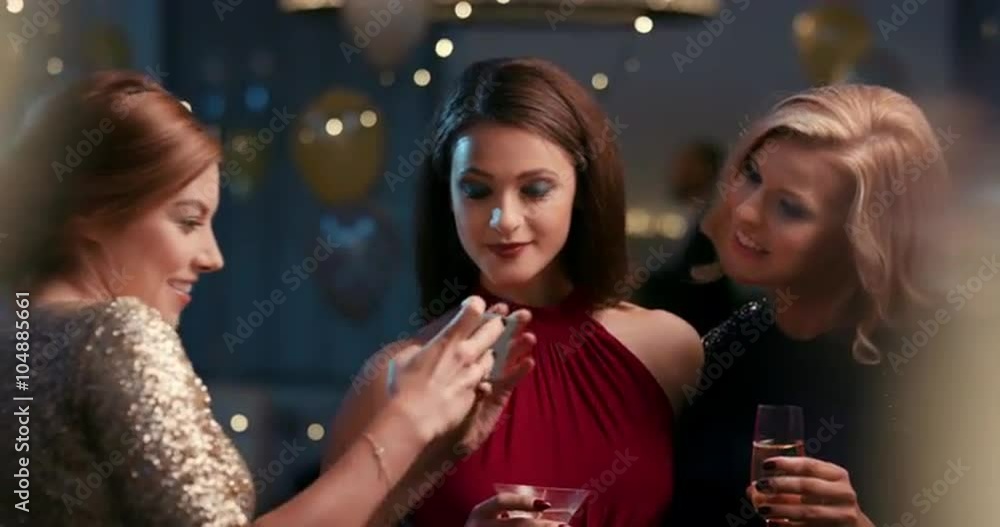 Beautiful woman at glamorous party taking photo with smart phone for social media sharing of sexy fashion event Beautiful woman at glamorous party taking photo with smart phone for social media sharing of sexy fashion event