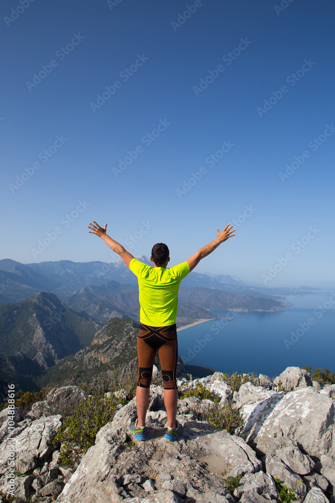Man practicing trail running with a coastal landscape in the background. Man practicing trail running with a coastal landscape in the background.