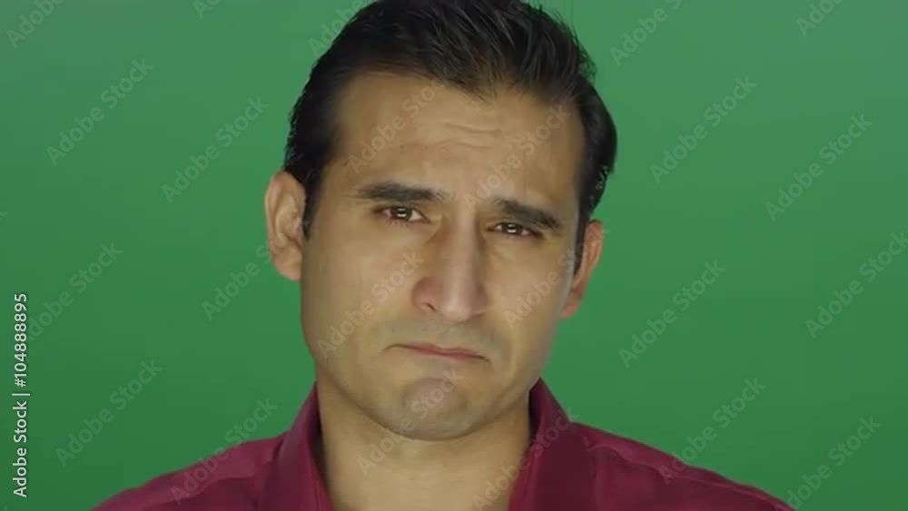 Ethnic man staring worryingly at the camera, on a green screen studio background Ethnic man staring worryingly at the camera, on a green screen studio background