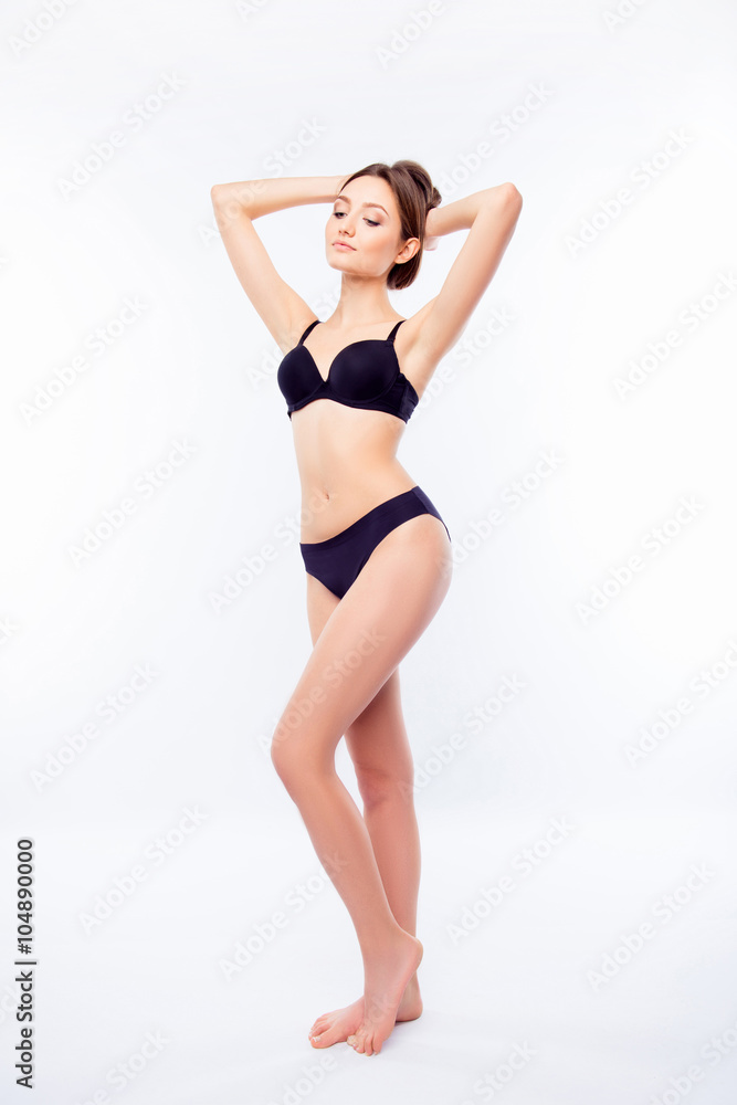 Young sexy woman in black undies snabding on a white background Young sexy woman in black undies snabding on a white background