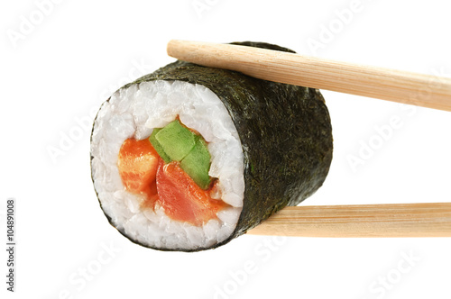 Fotografie Sushi rolls with avocado, salmon and spicy sauce. Chopsticks.