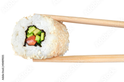 Sushi rolls with avocado, salmon and sesame seeds. Chopsticks.