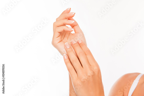 Close up photo of woman's hands with perfect skin on white back