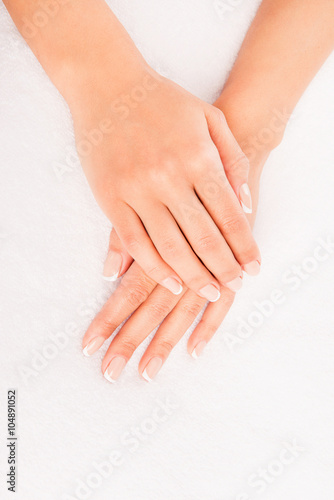 Close up photo of woman's hand with manicure on white background