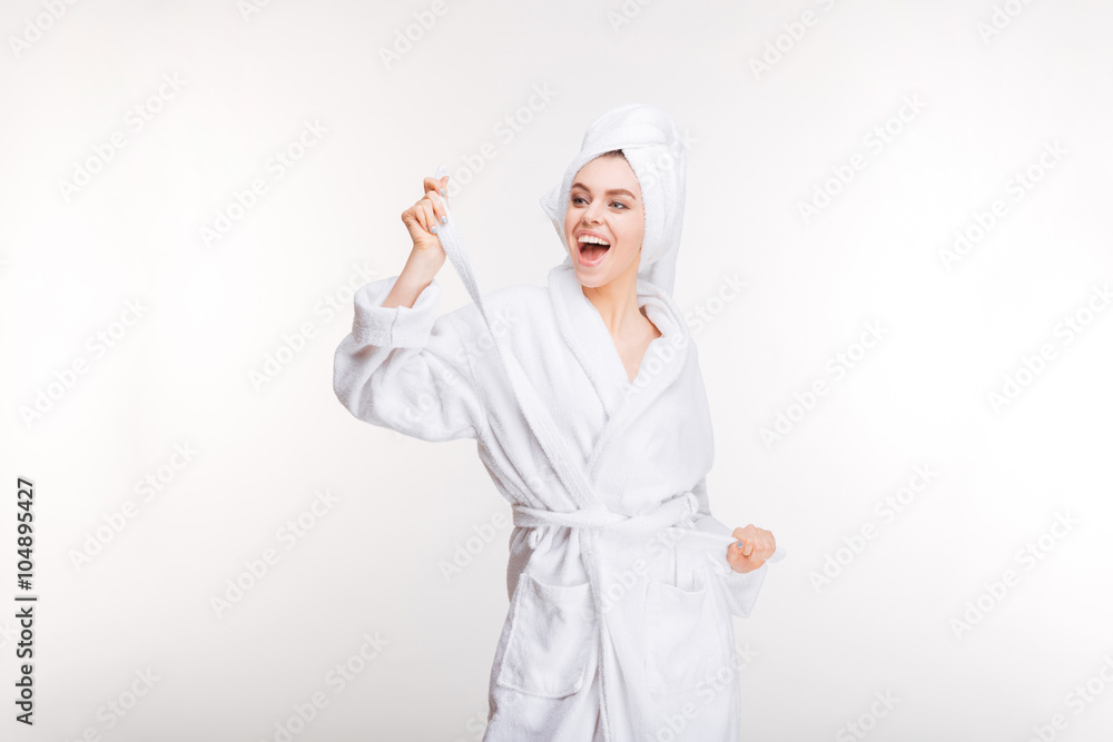 Cheerful joyful young woman in bathrobe with towel on head Cheerful joyful young woman in bathrobe with towel on head