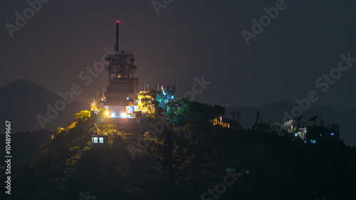 weather station on mountain at night timelapse, hong kong city
