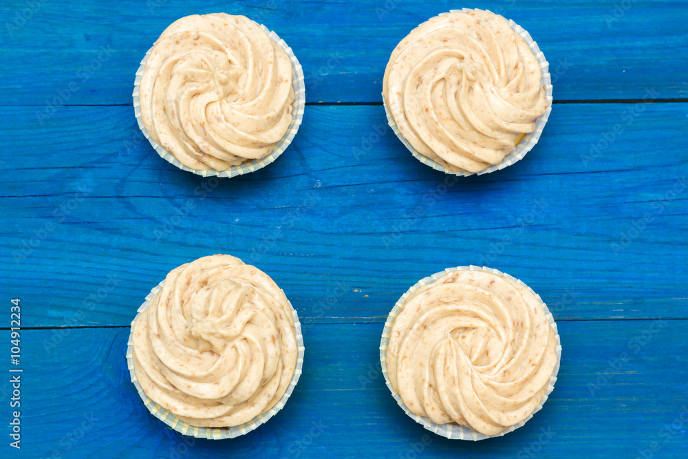 cupcakes with cream on the boards of blue cupcakes with cream on the boards of blue