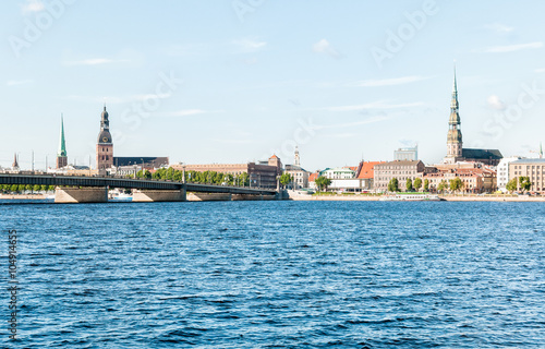 Rigas Cathedral and Saint Peters Church view across the Daugava river and Stone bridge, Latvia