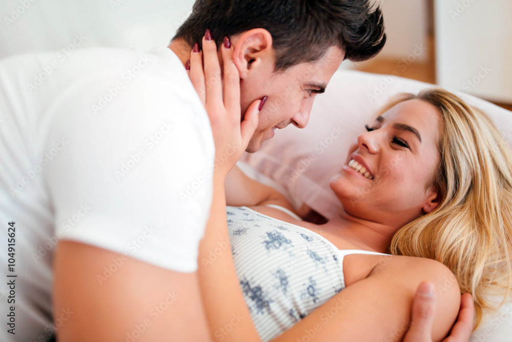 Handsome couple in bed being sensual Handsome couple in bed being sensual