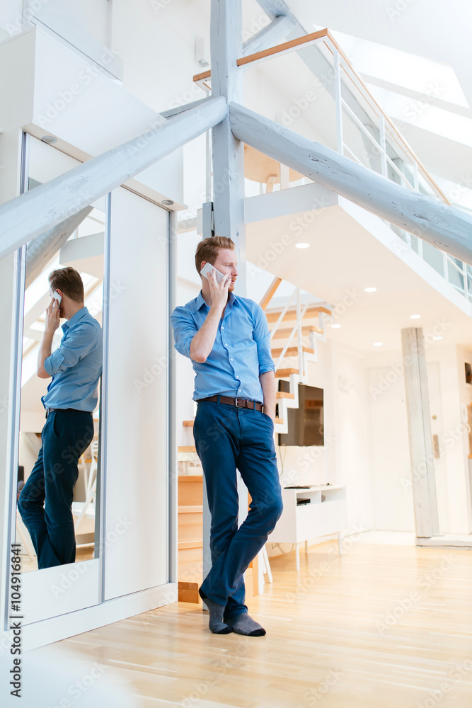 Man using phone in beautiful modern apartment Man using phone in beautiful modern apartment