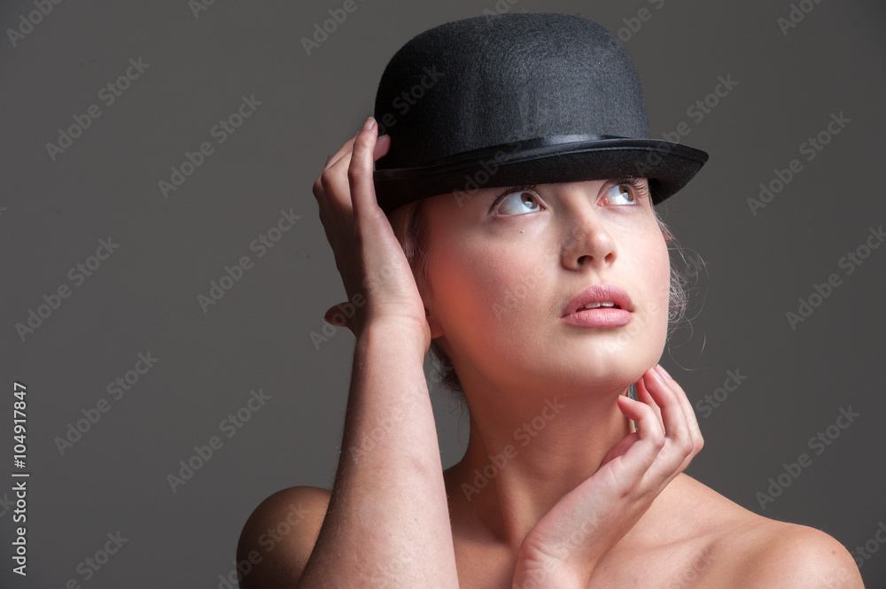 young lady posing in a black bowler hat
young lady posing in a black bowler hat
