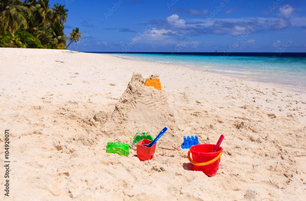 Sand castle on beach and kids toys Sand castle on beach and kids toys