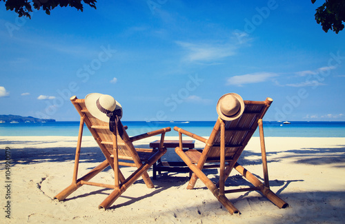 hats on chairs of tropical sand beach © nadezhda1906