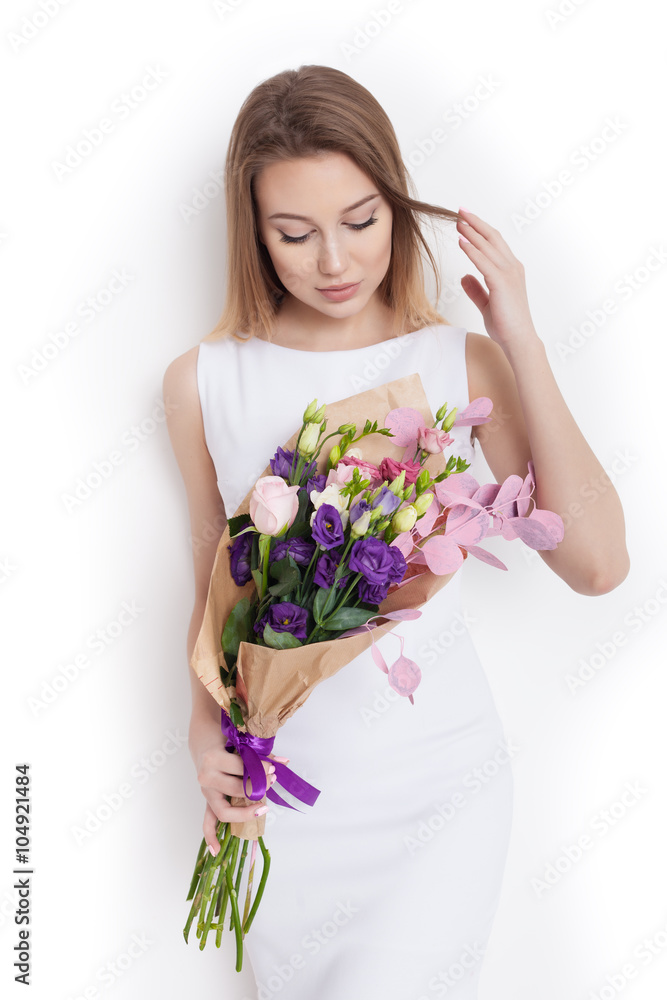 Young cute woman holding bunch of flowers