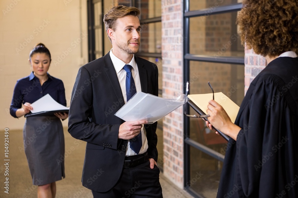 Lawyer looking at documents and interacting with businessman Lawyer looking at documents and interacting with businessman