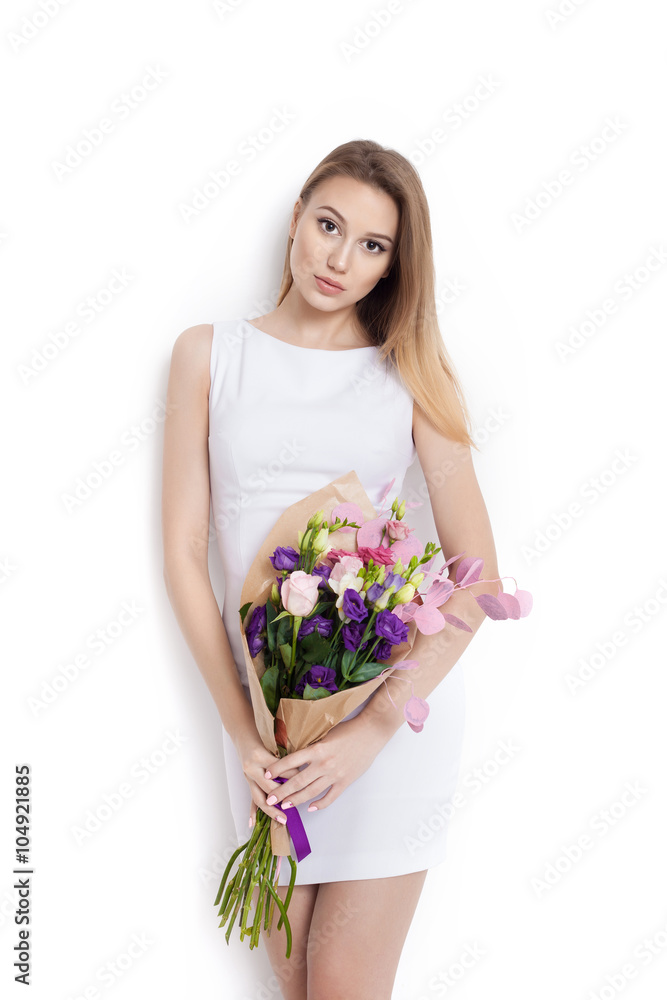 Young cute woman holding bunch of flowers Young cute woman holding bunch of flowers