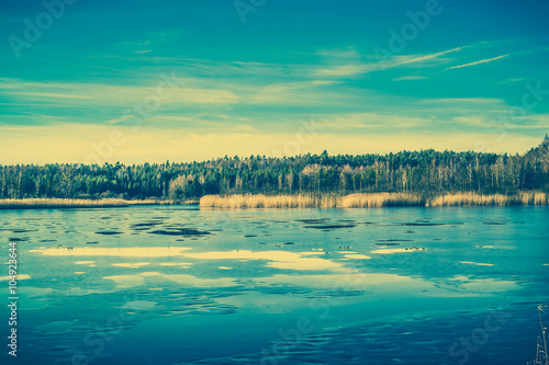 Surface of lake landscape with melting ice, vintage photo