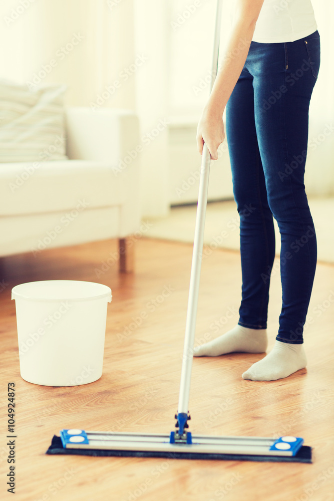 close up of woman with mop cleaning floor at home close up of woman with mop cleaning floor at home