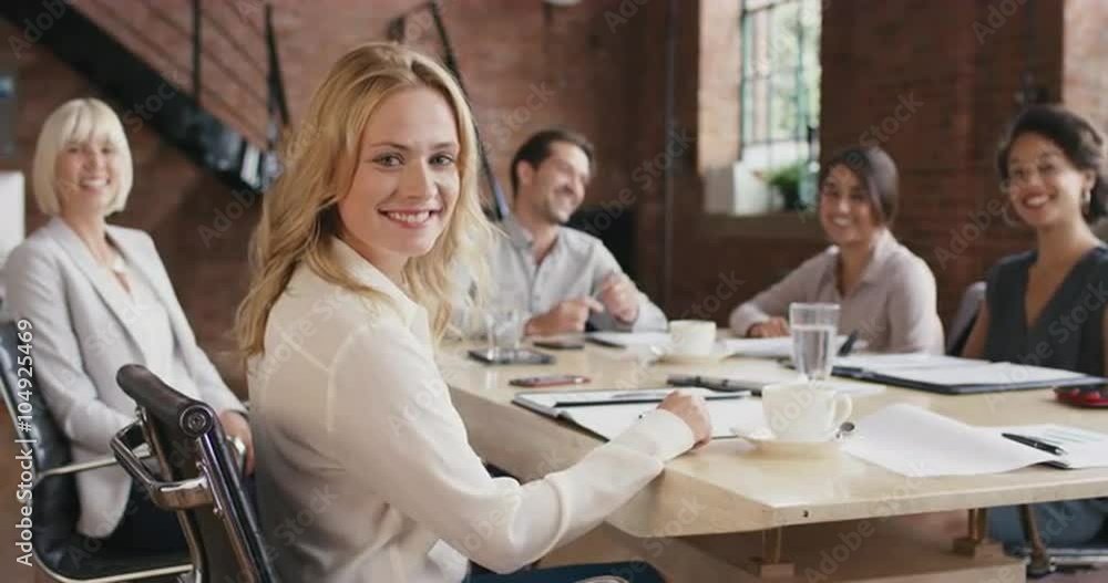 Portrait of a confident young business woman at boardroom table In slow motion turning around and smiling Portrait of a confident young business woman at boardroom table In slow motion turning around and smiling