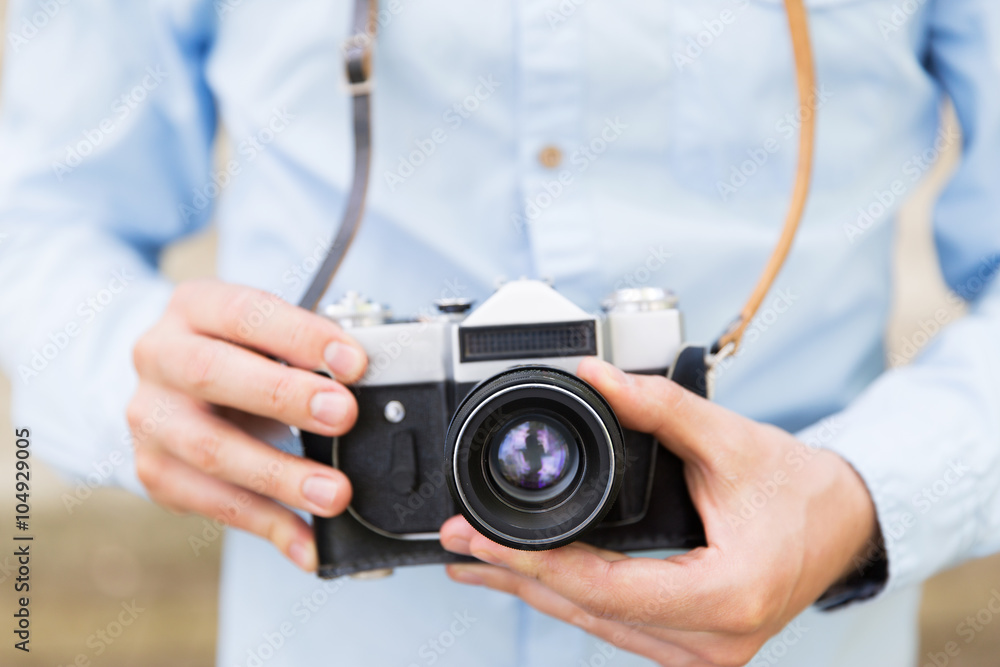 close up of hipster man with film camera in city close up of hipster man with film camera in city