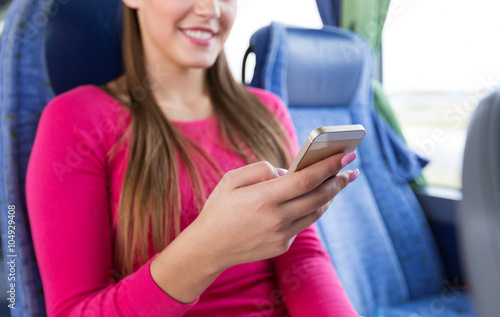 close up of woman in travel bus with smartphone