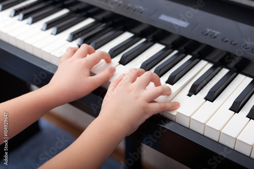 Child playing on a digital piano