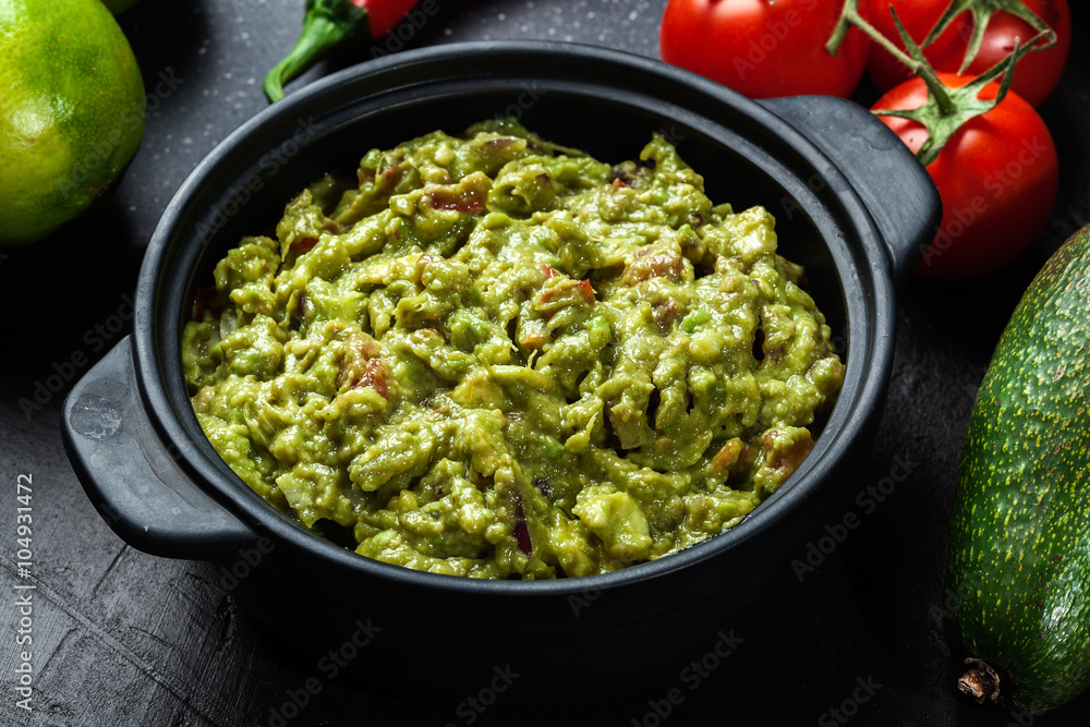 Bowl of guacamole with fresh ingredients Bowl of guacamole with fresh ingredients