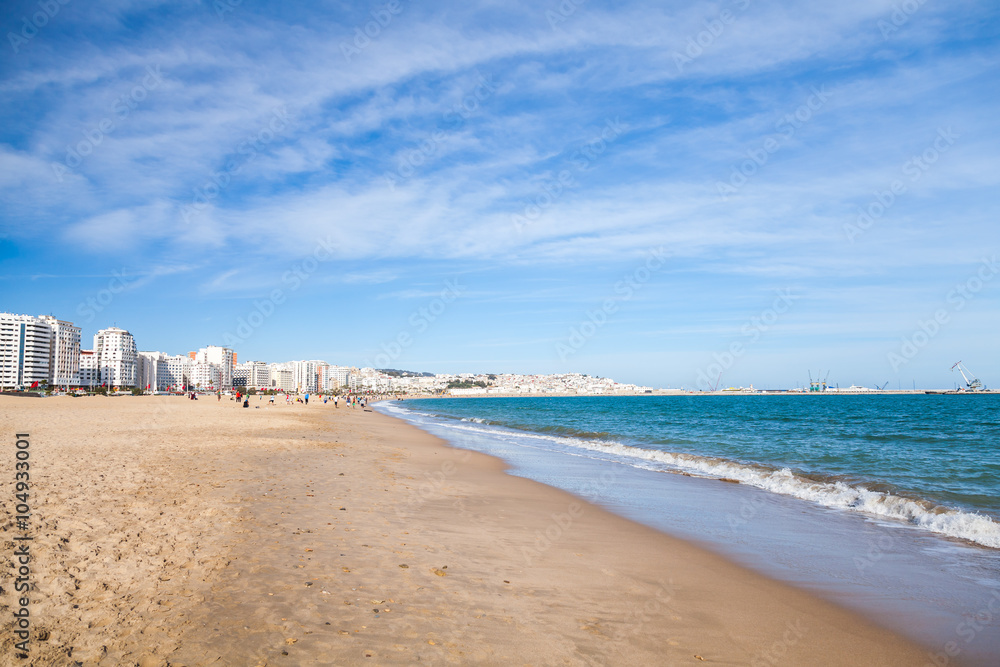 Tangier public beach with walking local people