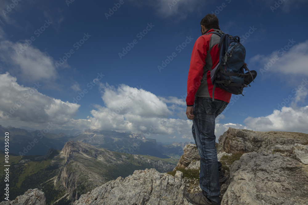 Tourist in Dolomite Mountains admiring the view