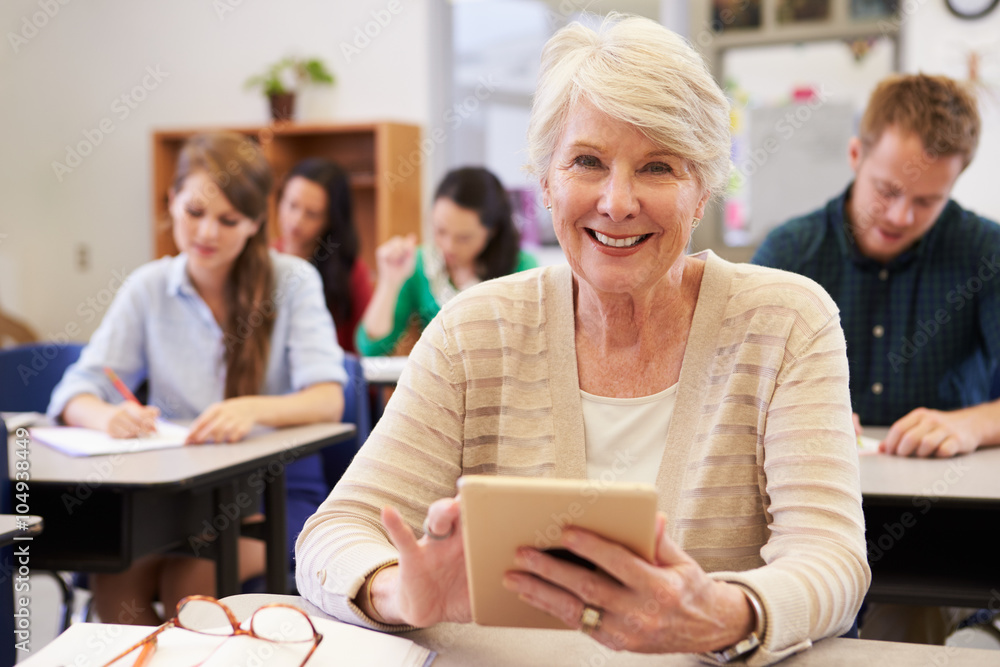 Senior woman using tablet computer at adult education class Senior woman using tablet computer at adult education class