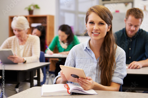 Young woman at adult education class looking to camera