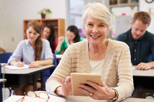 Senior woman using tablet computer at adult education class