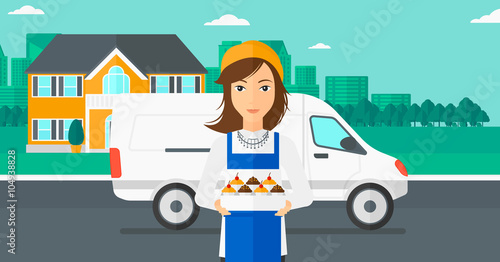 Baker holding box of cakes.