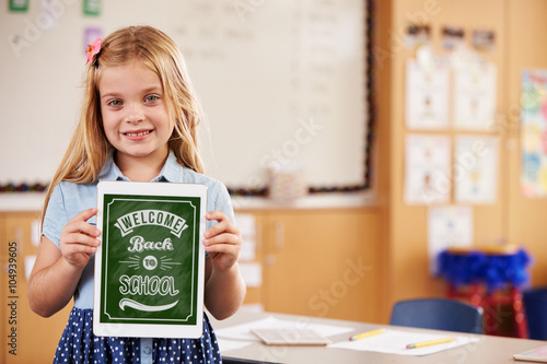 Portrait of elementary school girl holding a smart tablet