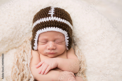 Newborn Baby Sleeping in Football Hat