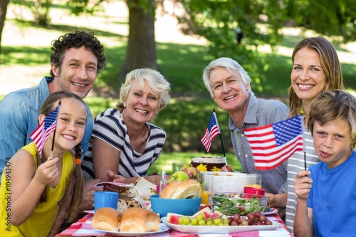 Family with American flag having a picnic