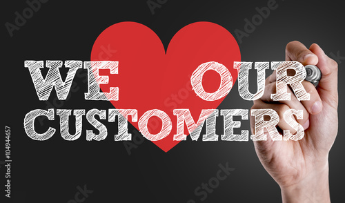 Hand writing the text: We Love Our Customers