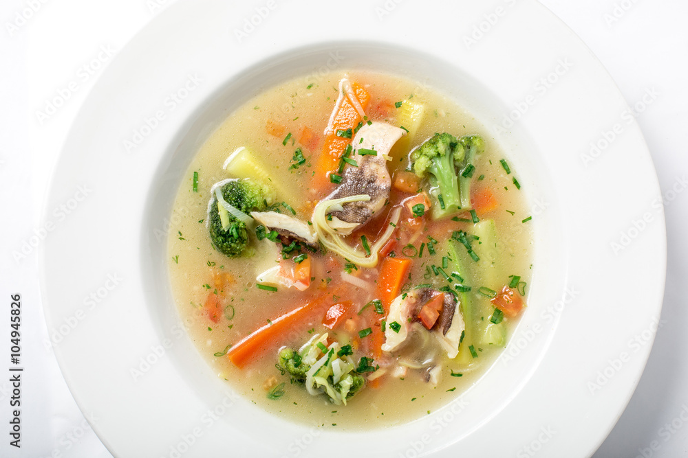 Light fish soup with vegetables and broccoli in white plate. Light fish soup with vegetables and broccoli in white plate.