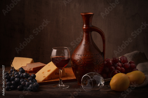 Still life with wine, grape and cheese