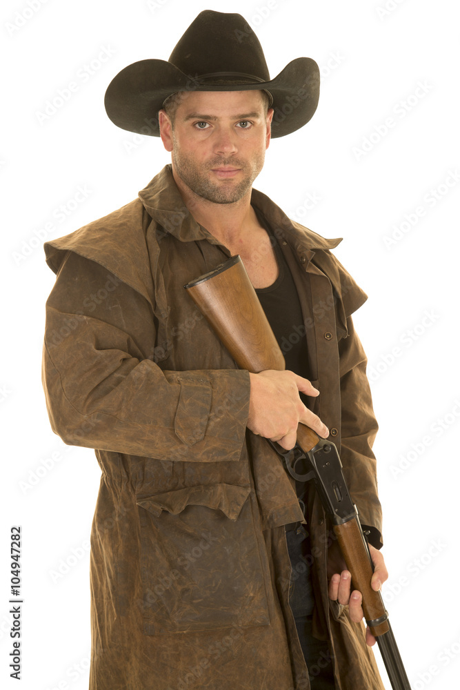 cowboy in black hat and duster holding rifle