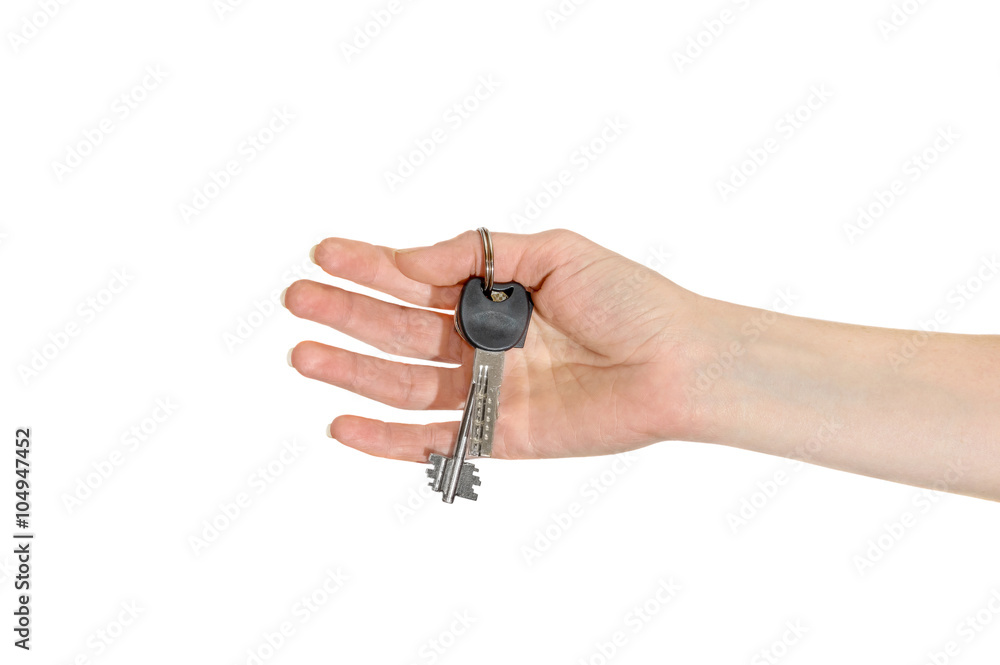 The keys in female hand isolated on white The keys in female hand isolated on white