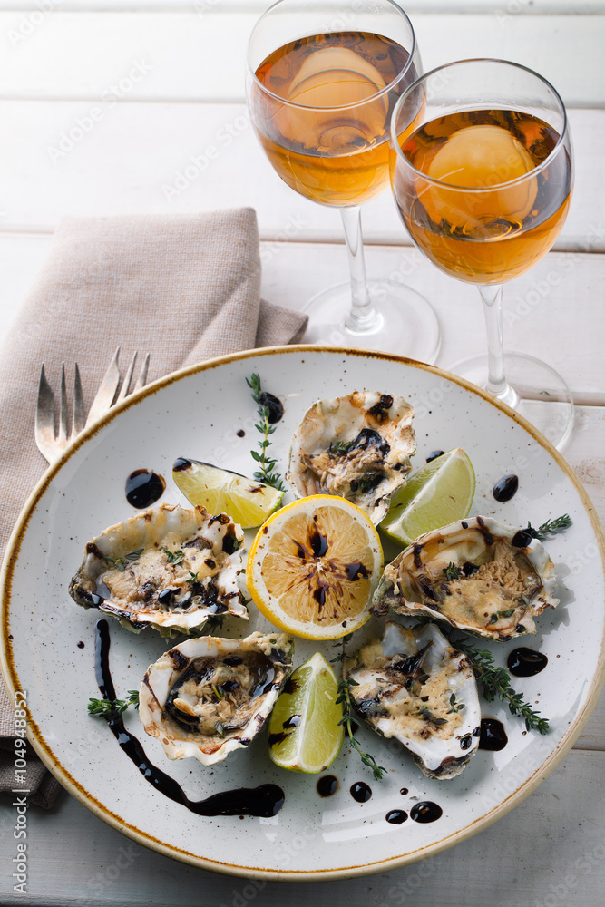 Baked oysters with sauce and cheese on a plate Baked oysters with sauce and cheese on a plate