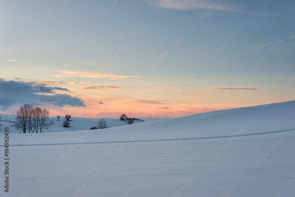 winter landscape at evening sunset and glowing sky clouds winter landscape at evening sunset and glowing sky clouds